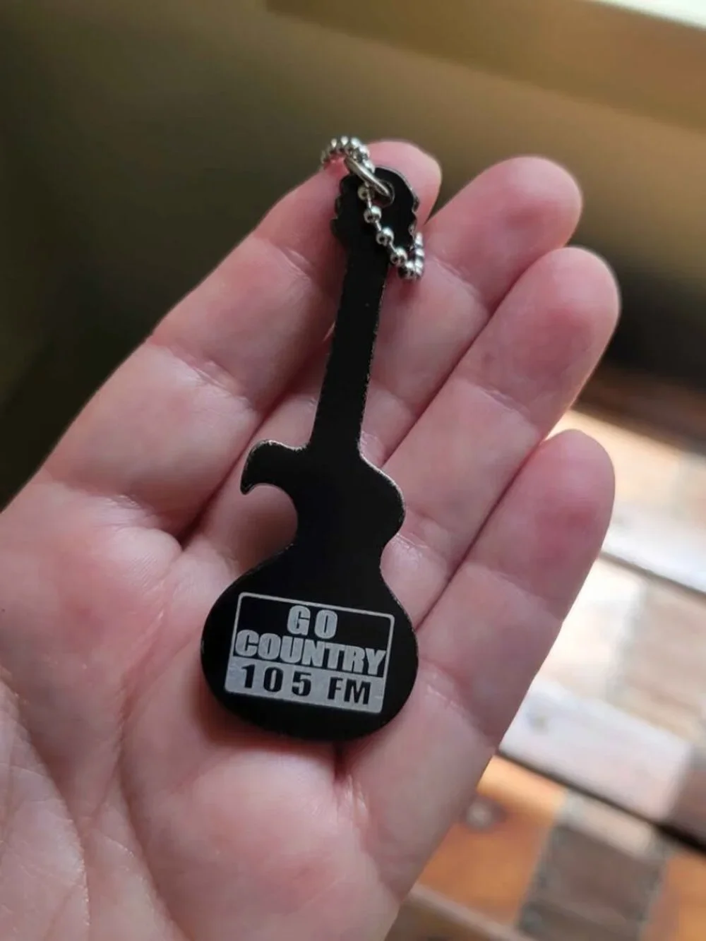 Guitar-Shaped Black Keychain And Promotional Bottle Opener